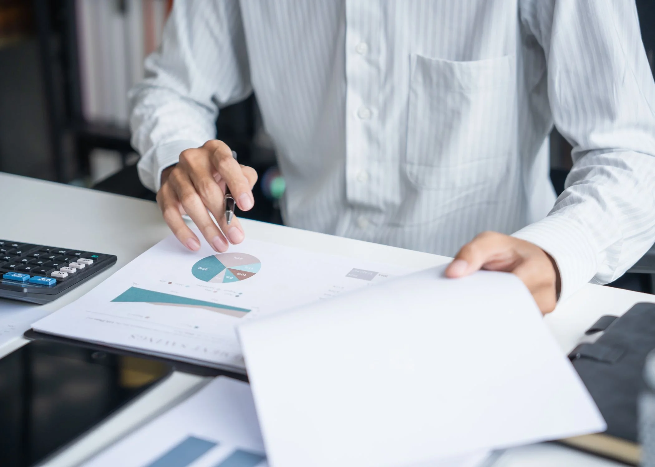 Person analyzing charts and documents from DSO network database